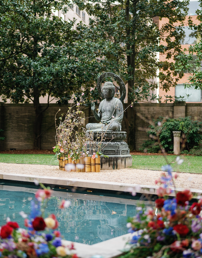 Purple and Wine flowers by Tan Austin Floral in pool setting for Art in Bloom DC